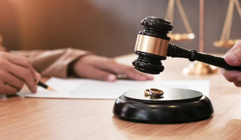 A wedding rings on a judge's gavel to convey divorce.