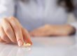 A woman placing her wedding ring on a marble table.
