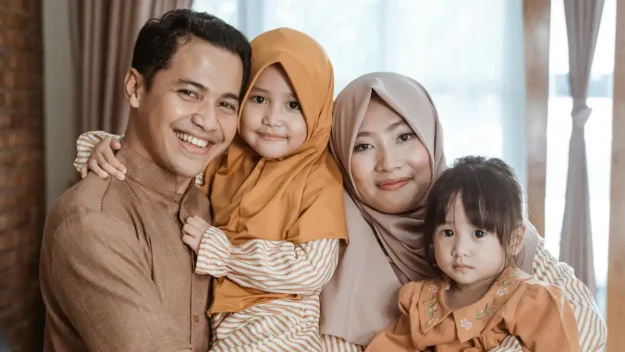 an family posing for a photo in their living room