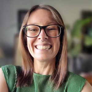 claire pauling looks into the camera smiling