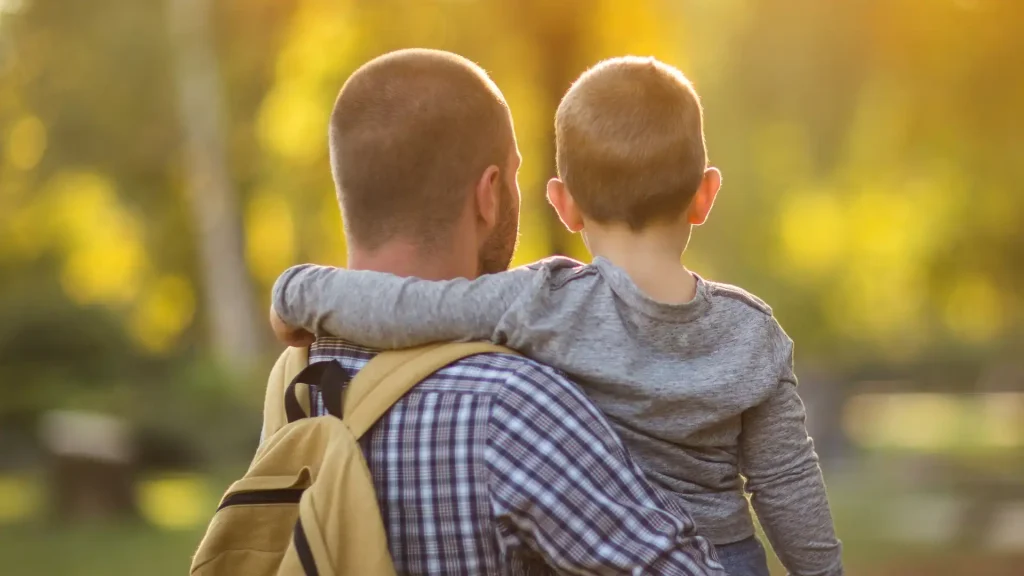 photo of a parent and son clicked from backside. child support 