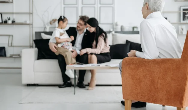 a family sitting on a couch in a living room