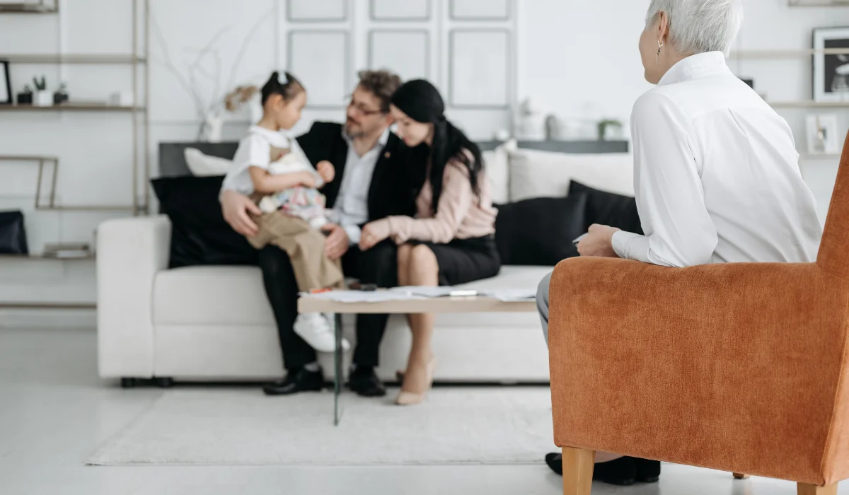 a family sitting on a couch in a living room