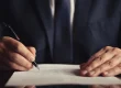 A lawyer writing on a document