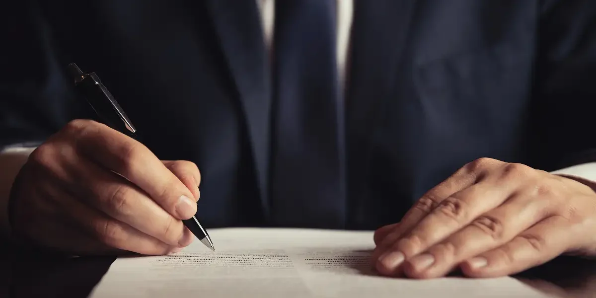 A lawyer writing on a document