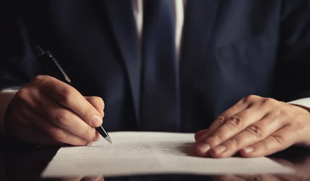 A lawyer writing on a document