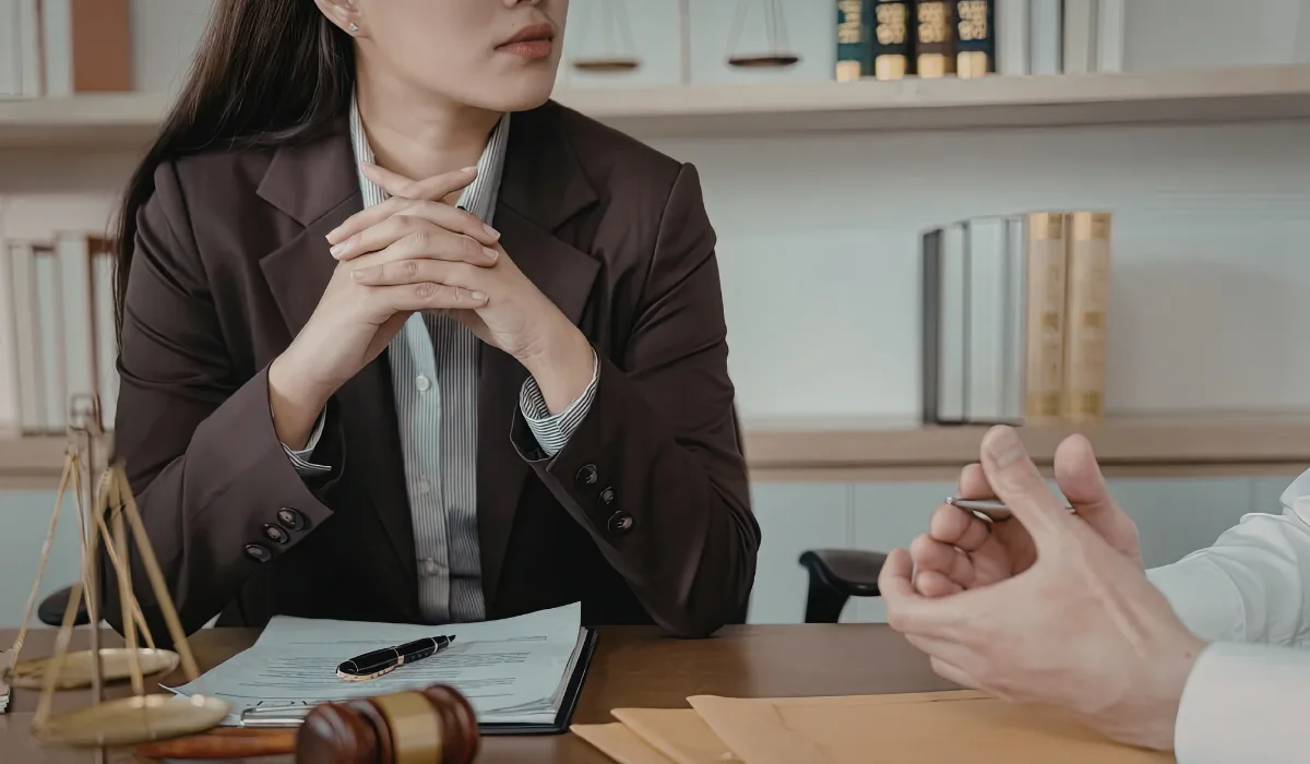 A lawyer listening to a person in an office.