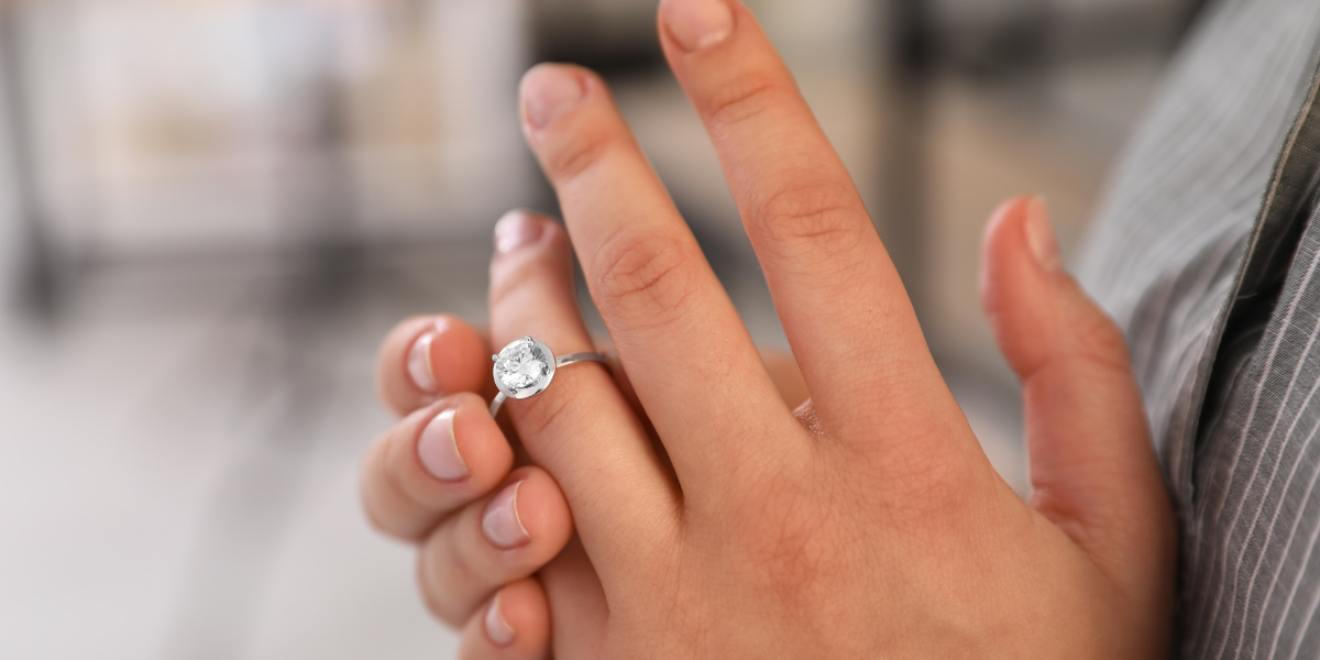 Person showing an engagement ring on their finger