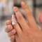 Person showing an engagement ring on their finger