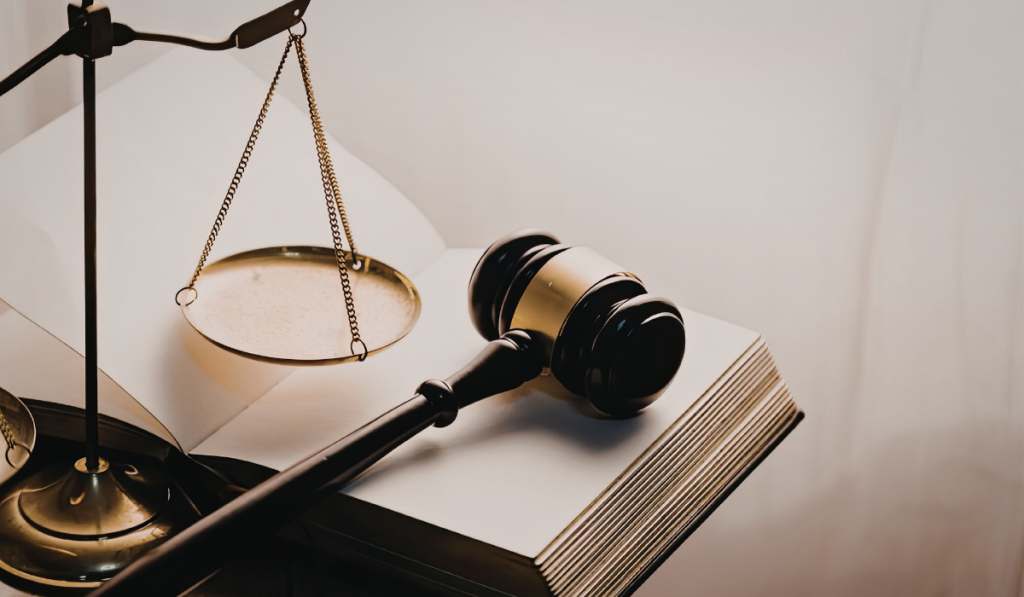 Gavel, legal scales, and law book on a desk