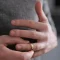 Person removing a wedding ring from their finger